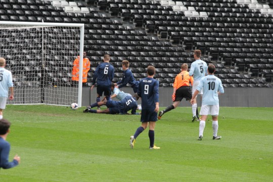 Kent comes out too far and allows Oxford to hit the post.