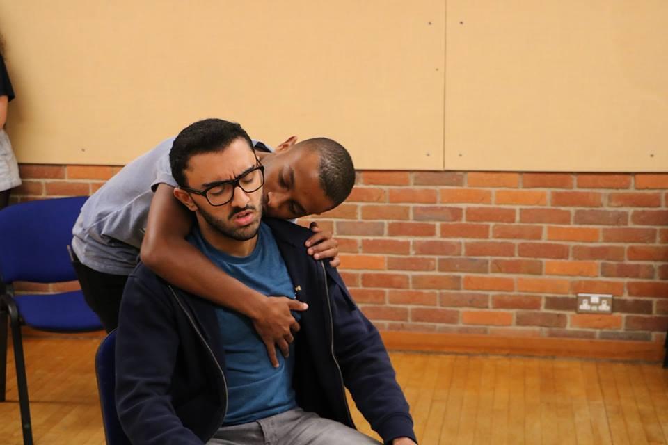 Abbas Khan (Hamed) and Joshua Marchant (ensemble) rehearse an intimate scene. Photo credits: Emma Hall