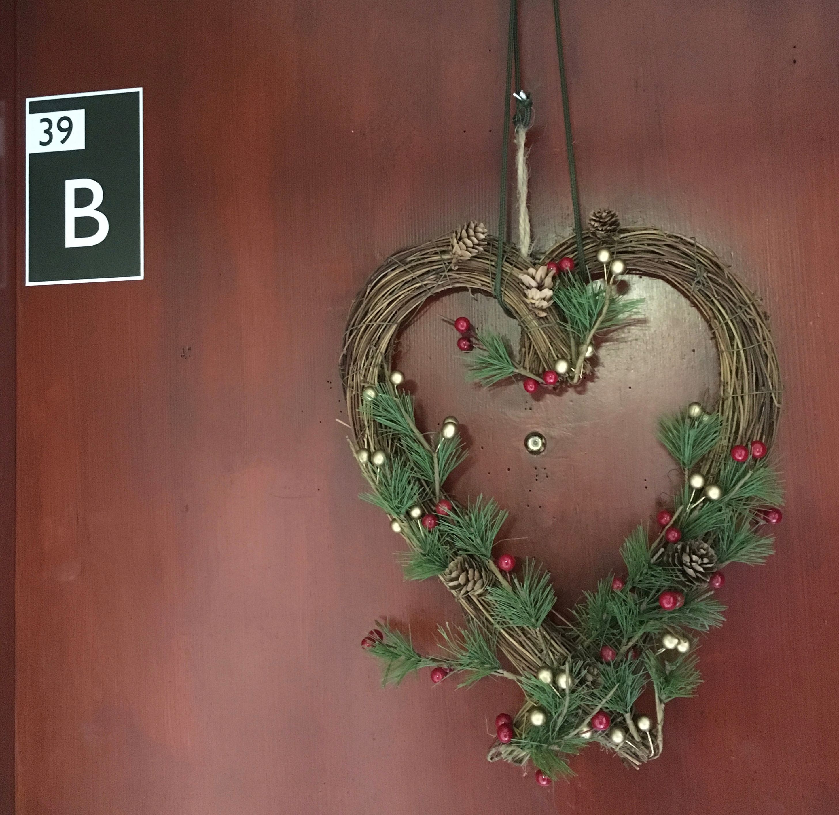 Image may contain: Wreath, Trademark, Logo, Vase, Pottery, Potted Plant, Plant, Jar, Flora