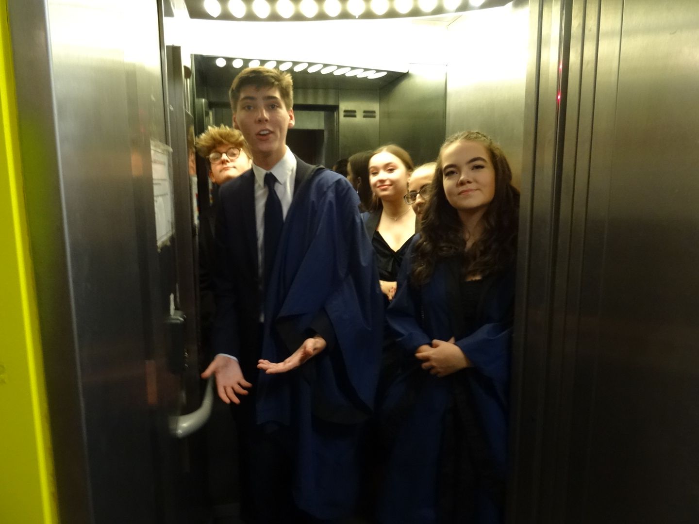 Image may contain: Suit, Overcoat, Coat, Clothing, Person, People, Human, Elevator