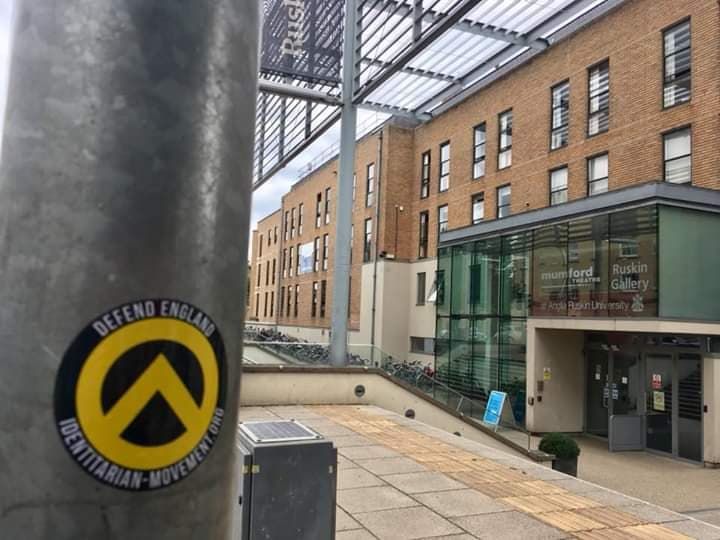 Image may contain: Alley, Alleyway, Office Building, Outdoors, Convention Center, City, Road, Town, Urban, Street, Architecture, Sticker, Building, Label, Text
