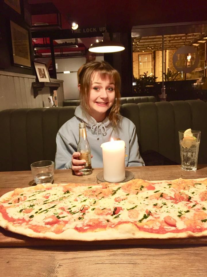 Image may contain: Female, Dining Room, Candle, Dish, Room, Dining Table, Meal, Table, Interior Design, Indoors, Furniture, Pizza, Food, Person, Human