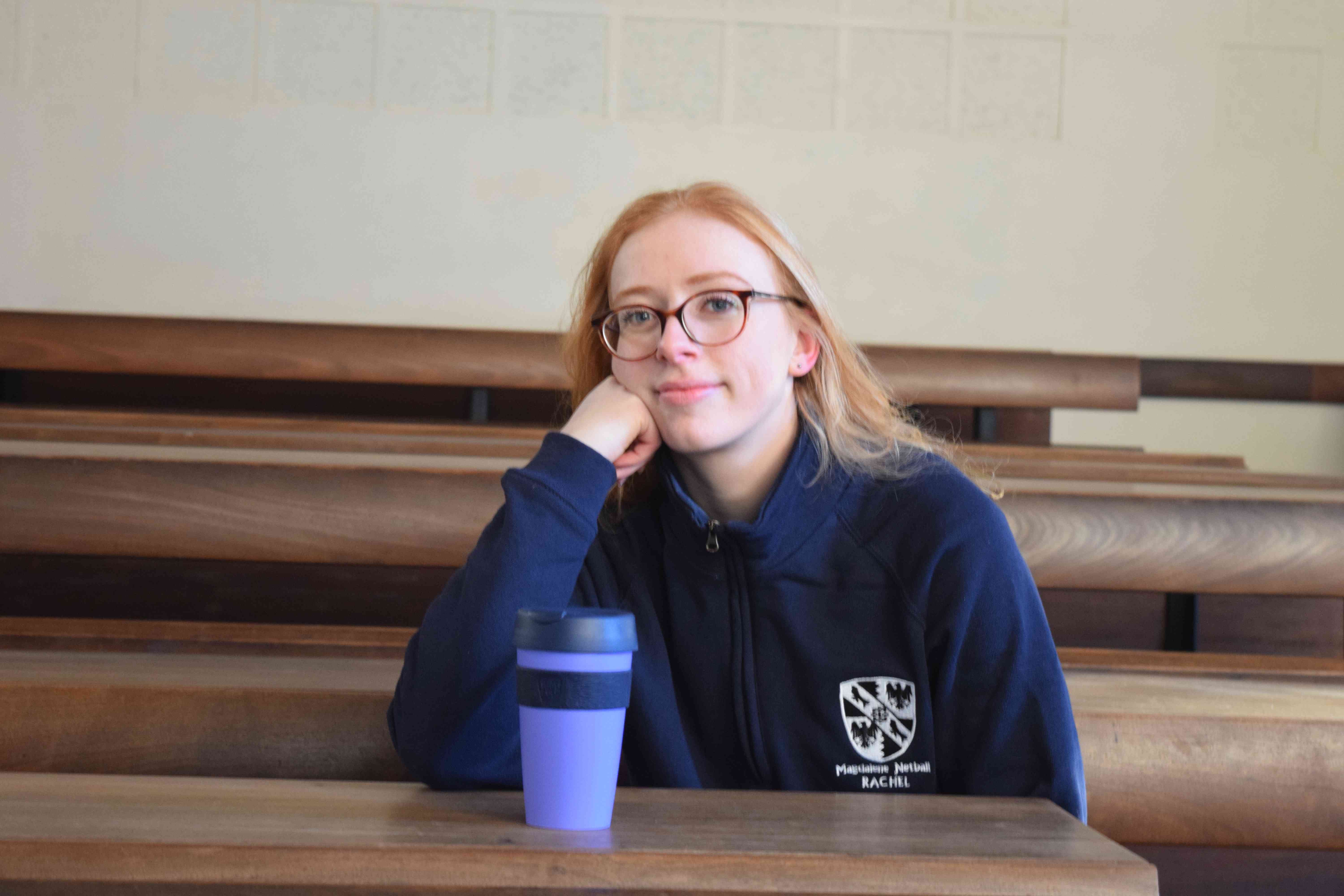 Image may contain: Finger, Hardwood, Woman, Teen, Girl, Kid, Blonde, Child, Female, Plywood, Sitting, Wood, Accessories, Glasses, Accessory, Human, Person