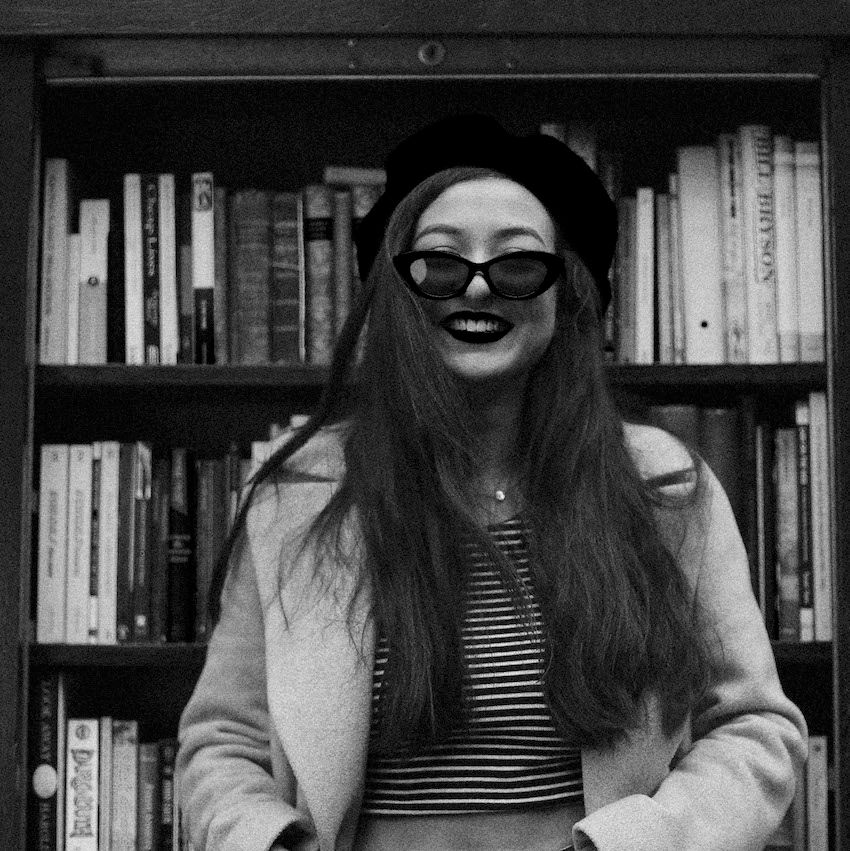 Image may contain: Glasses, Accessory, Accessories, Book, Library, Room, Indoors, Human, Person, Bookcase, Shelf, Furniture