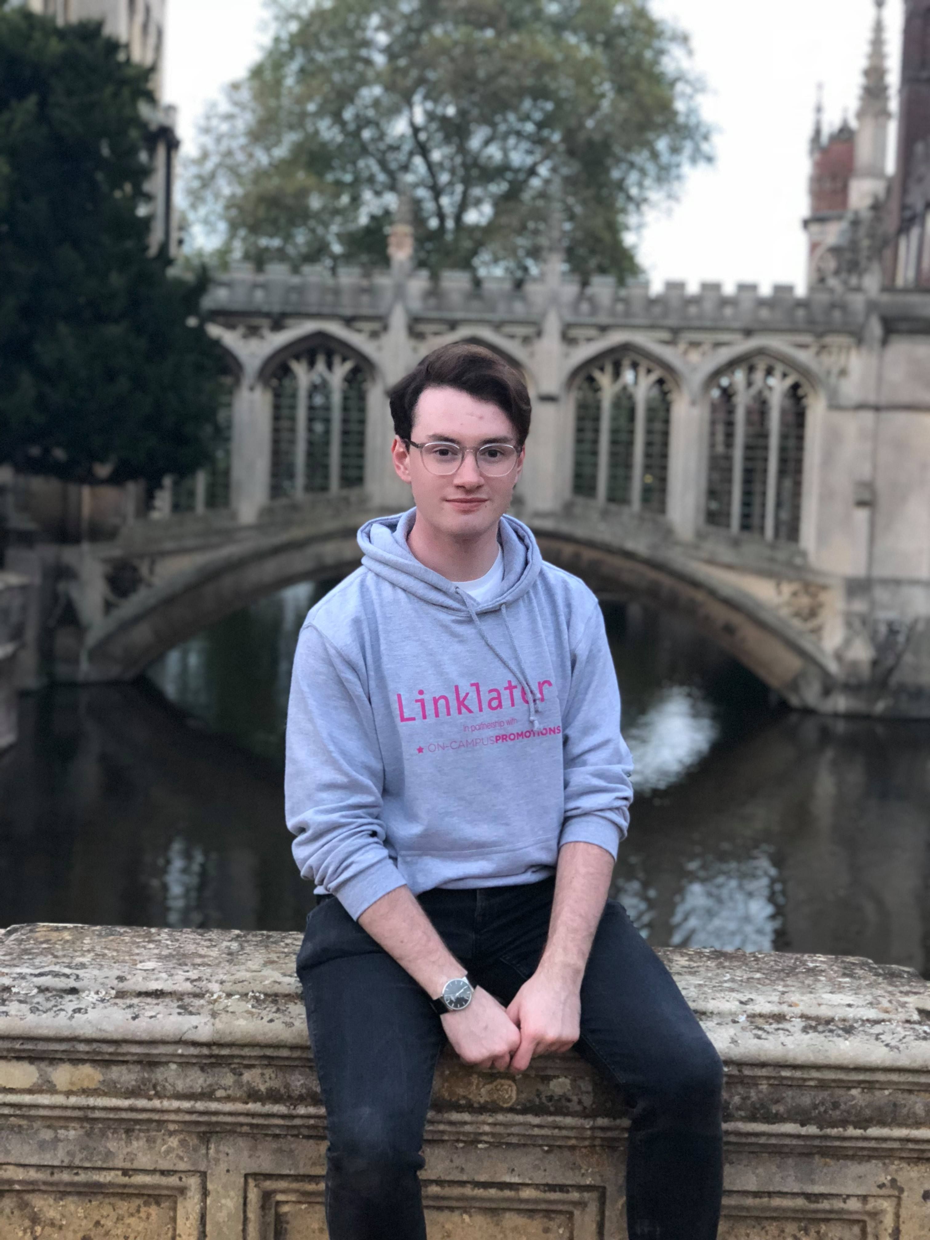 Image may contain: Sweatshirt, Pants, Sleeve, Canal, Sweater, Building, Bridge, Outdoors, Water, Person, Human, Clothing, Apparel