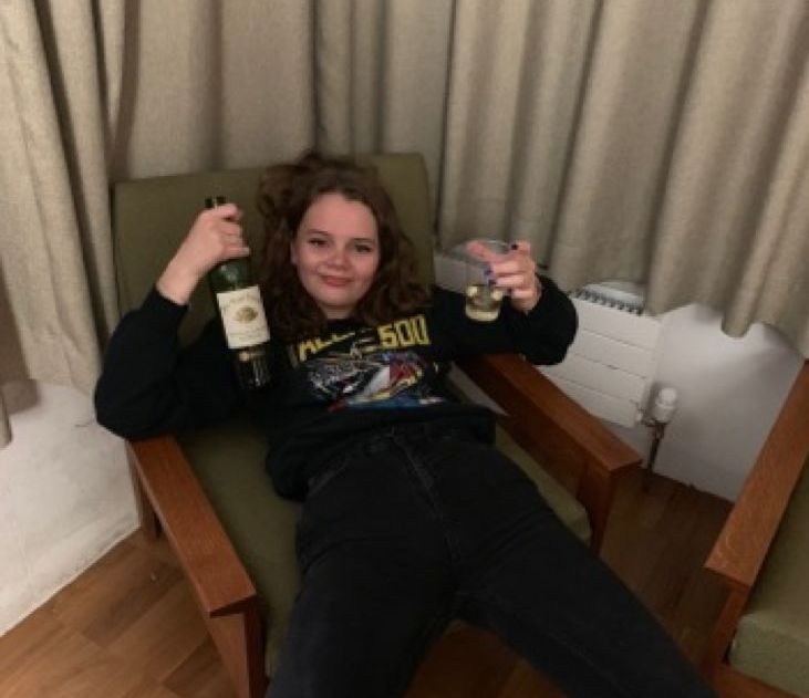 Image may contain: Chair, Beer Bottle, Wood, Female, Face, Bottle, Denim, Jeans, Couch, Person, Human, Furniture, Alcohol, Beverage, Beer, Drink, Pants, Clothing, Apparel