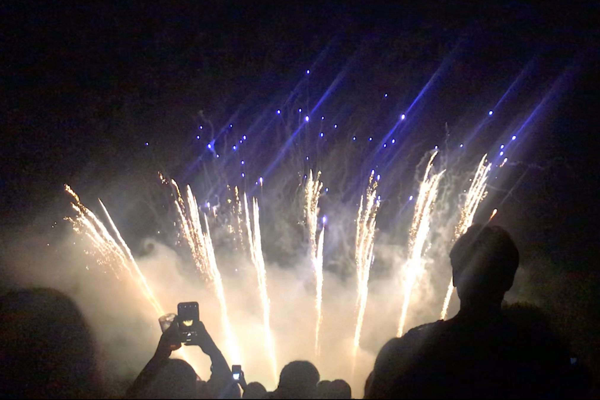 Image may contain: Crowd, Light, Flare, Human, Person, Fireworks, Night, Outdoors, Nature