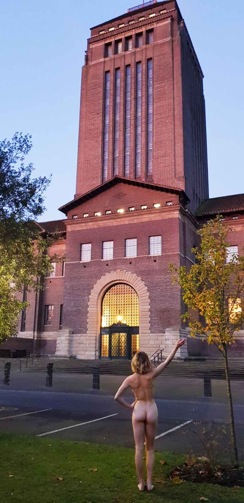 Image may contain: Clock Tower, Female, Apparel, Clothing, Steeple, Spire, Campus, Bell Tower, Downtown, Neighborhood, City, Town, Urban, Human, Person, Tower, Architecture, Building