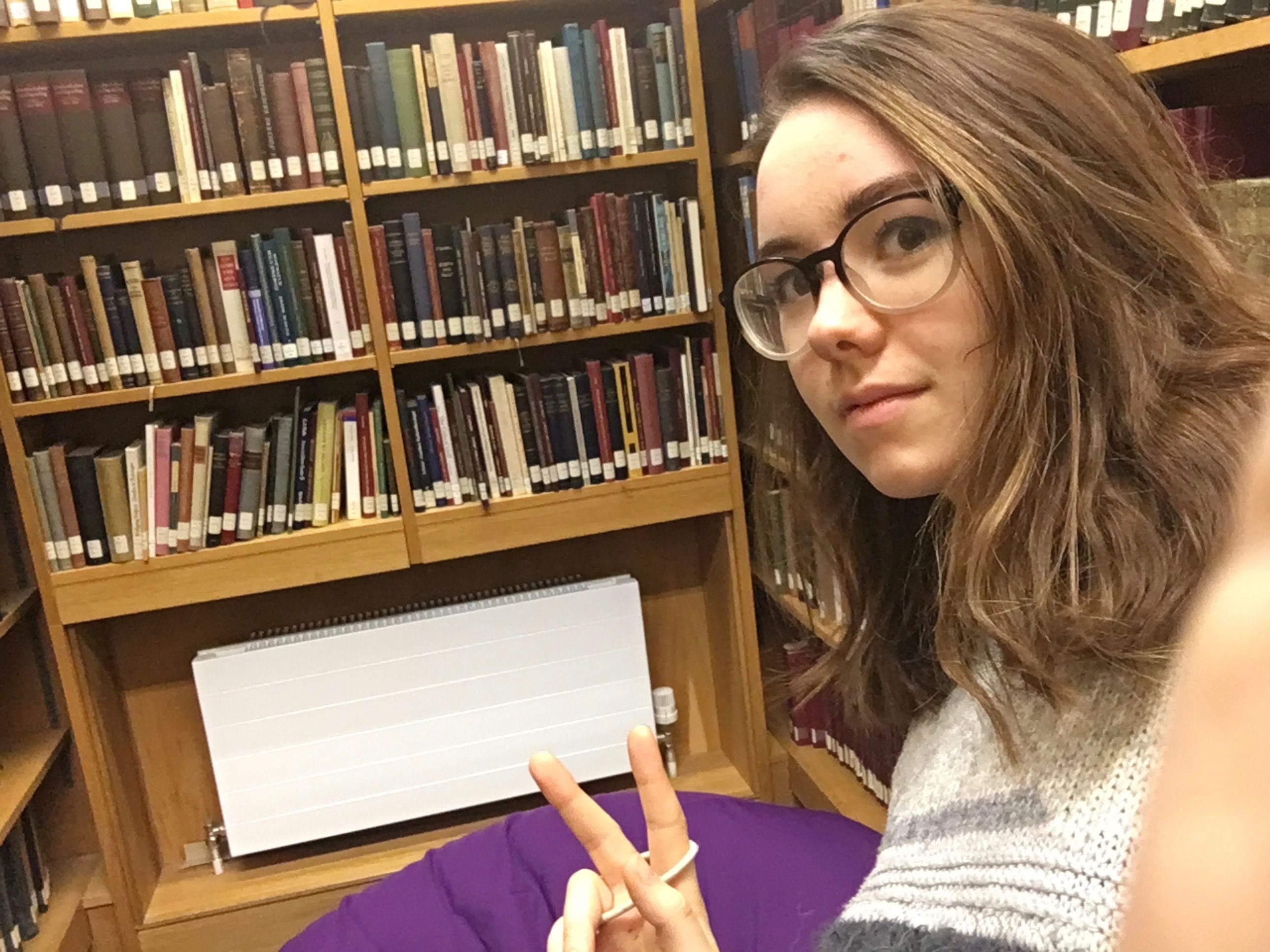 Image may contain: Bookcase, Shelf, Furniture, Accessory, Accessories, Glasses, Book, Library, Person, Human, Indoors, Room
