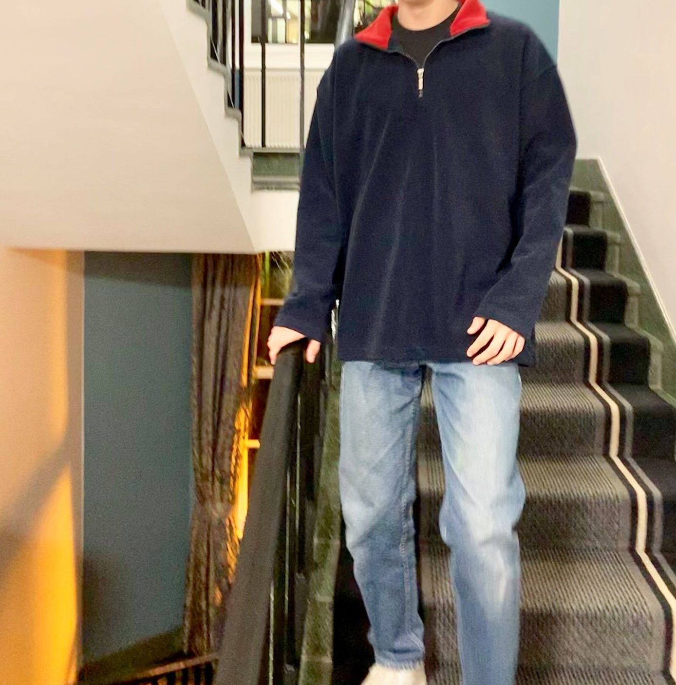 Image may contain: Denim, Jeans, Staircase, Long Sleeve, Person, Human, Sleeve, Pants, Apparel, Clothing, Banister, Handrail