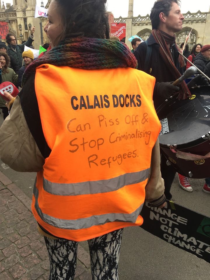 Image may contain: Banner, Crowd, Text, Shoe, Clothing, Apparel, Footwear, Human, Person