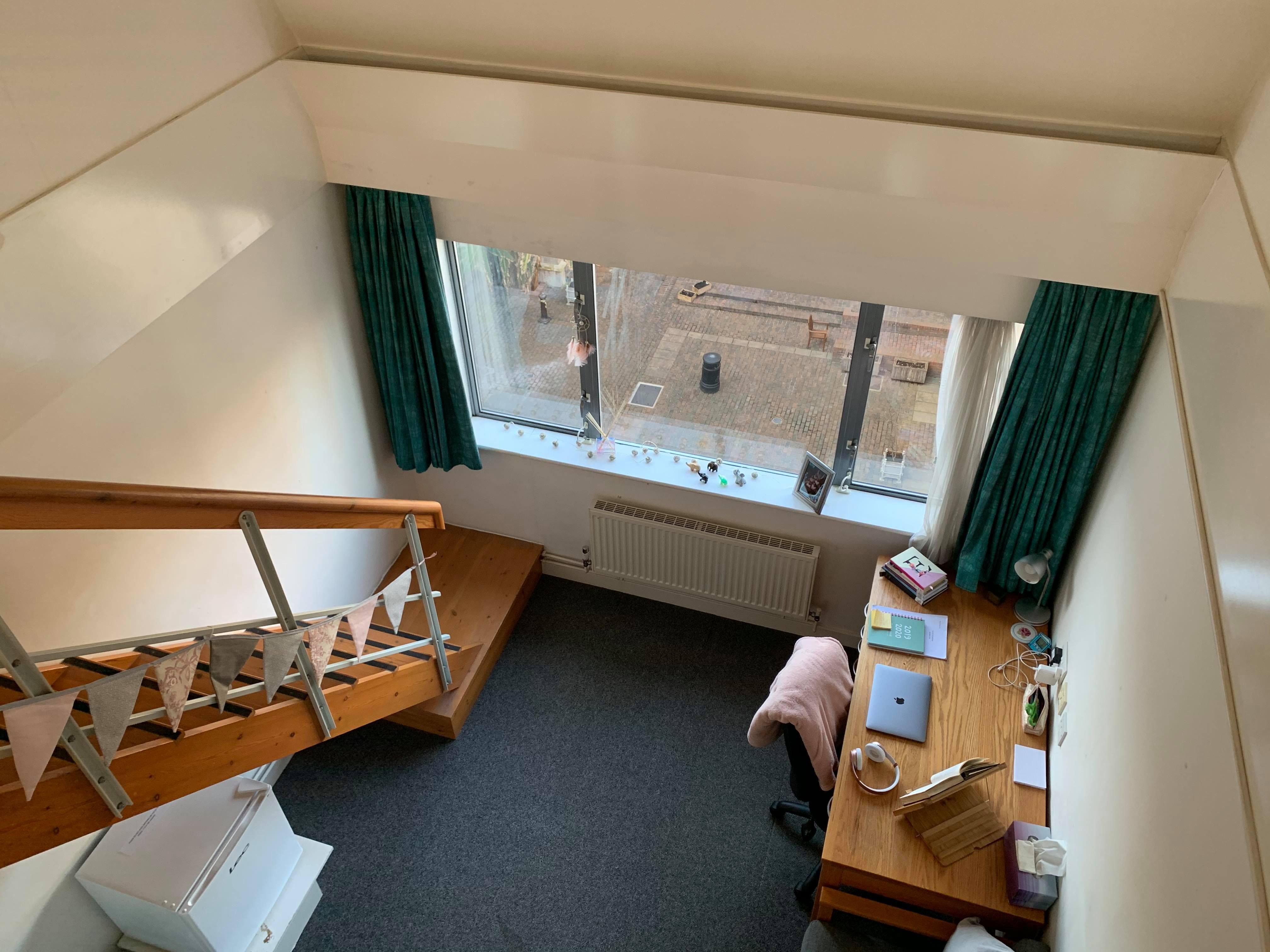 Image may contain: Hostel, Dorm Room, Plywood, Floor, Hardwood, Living Room, Indoors, Bedroom, Room, Flooring, Wood, Housing, Building
