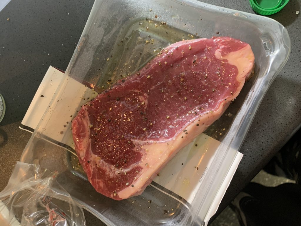 Steak in packet with salt, pepper and oil