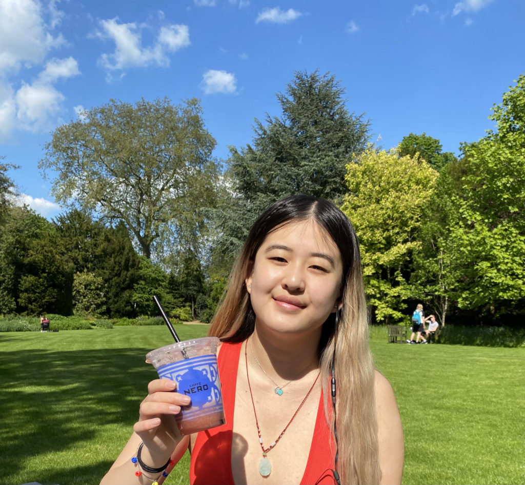 Girl smiling and holding a drink