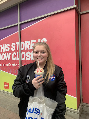 Girl smiling holding a drink