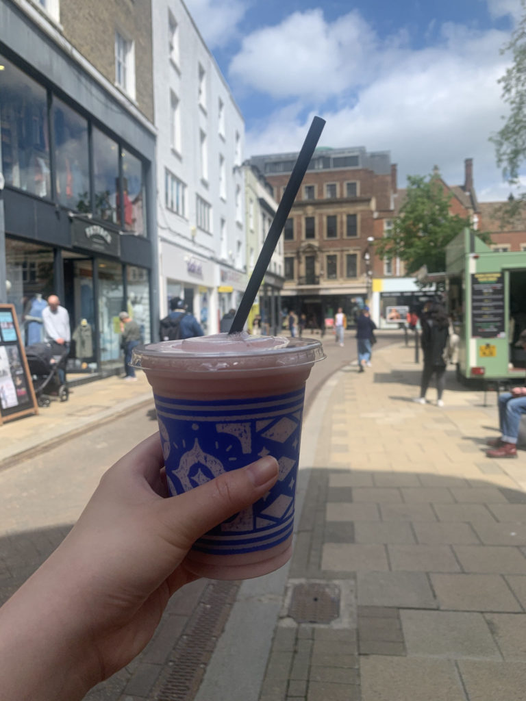 Hand holding a Caffè Nero fruit booster
