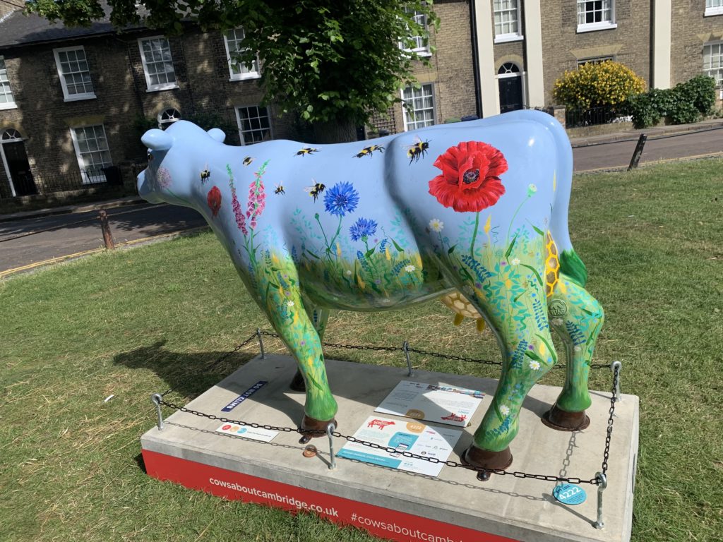 Blue cow statue with flowers painted onto it