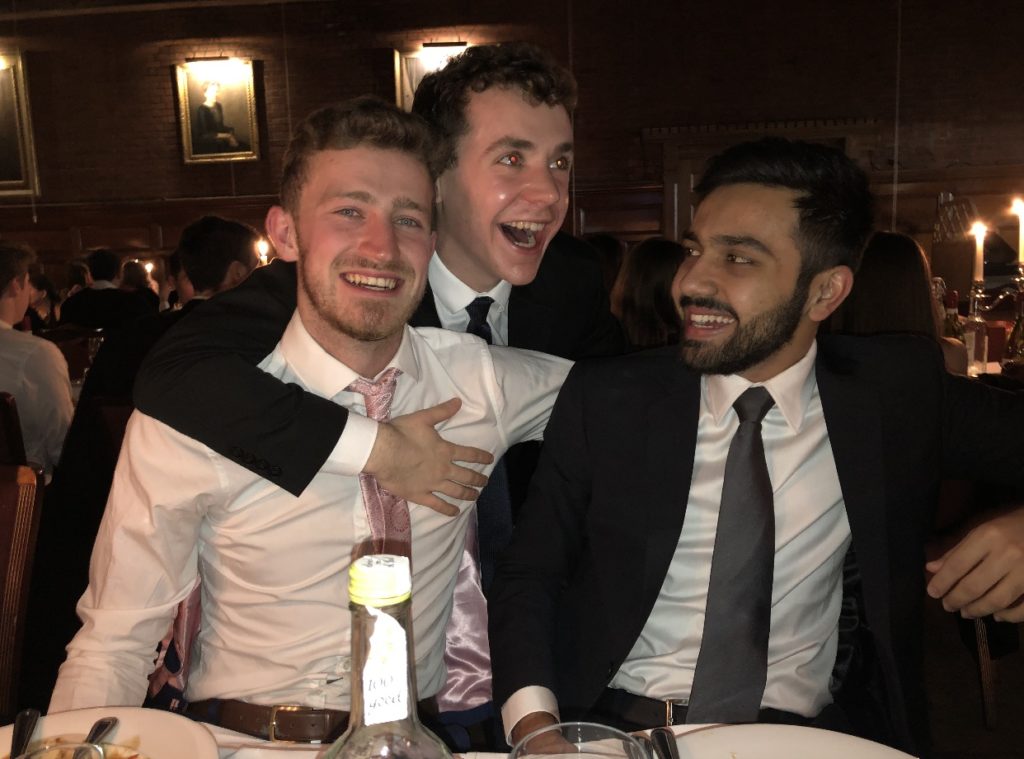 James at a formal dinner with two male friends