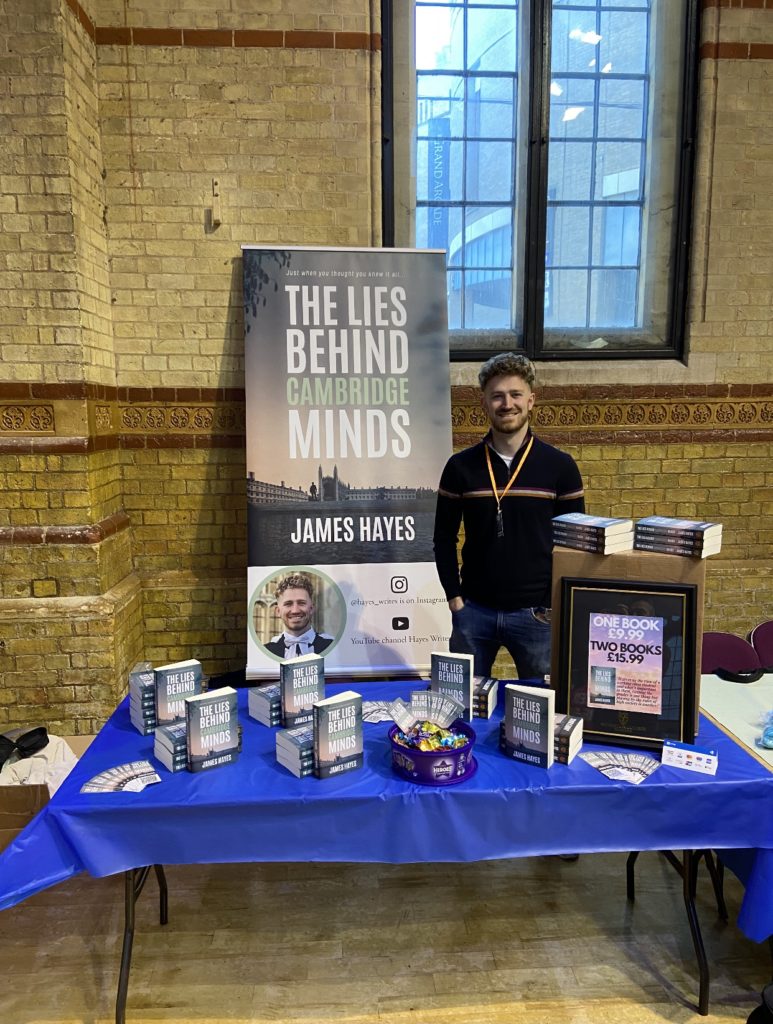 James standing at his stool at refresher's fair