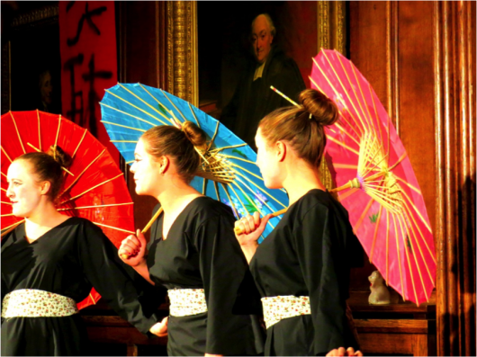 The three little maids performing with parasols Credit: Nana Dei-Anang