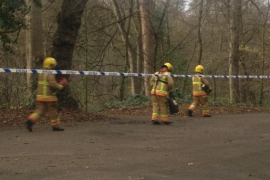 Firemen are at the scene where the body was found.