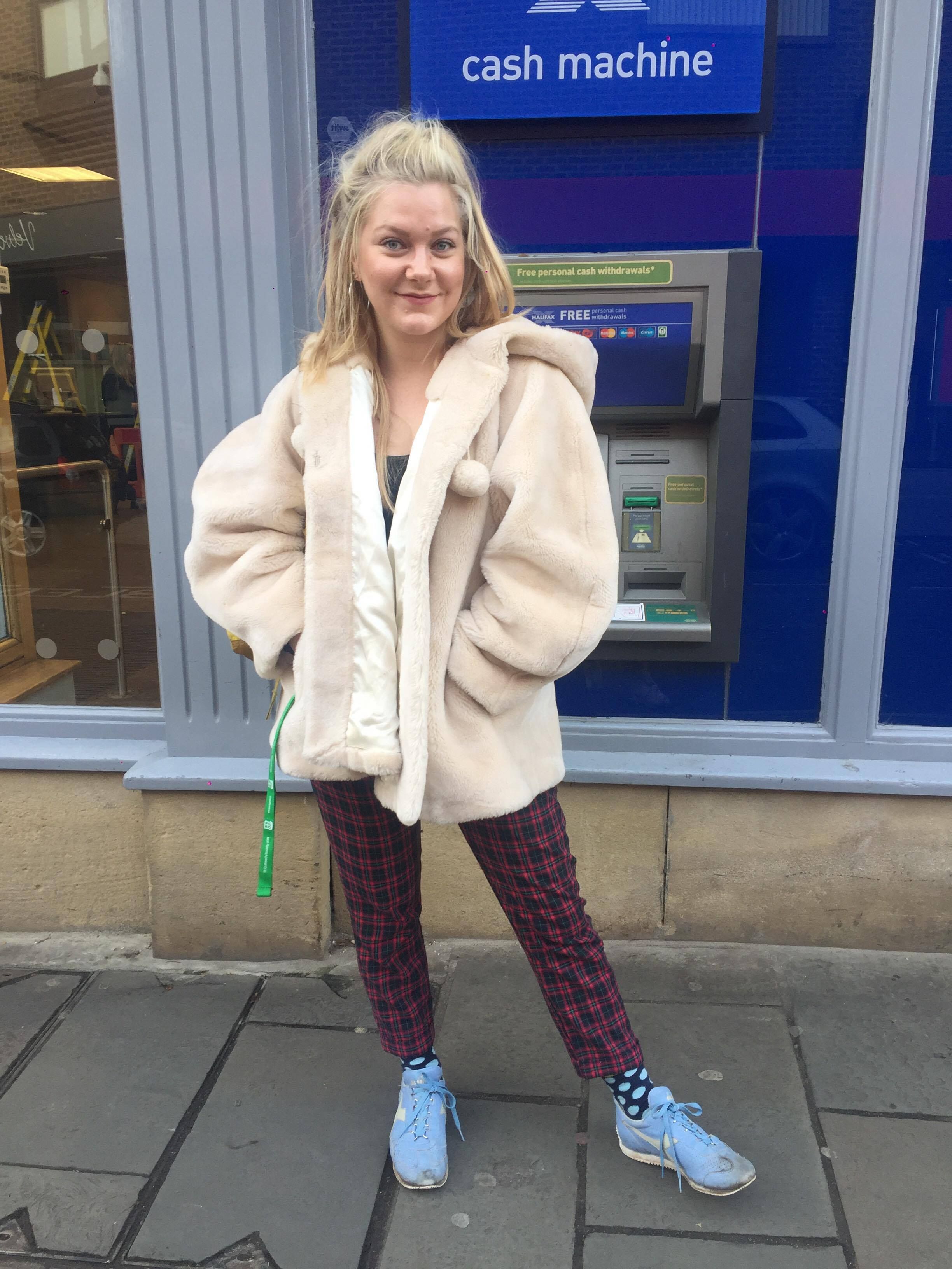 Image may contain: Sweater, Clothing, Cardigan, Cash Machine, Atm, Human, Person, People