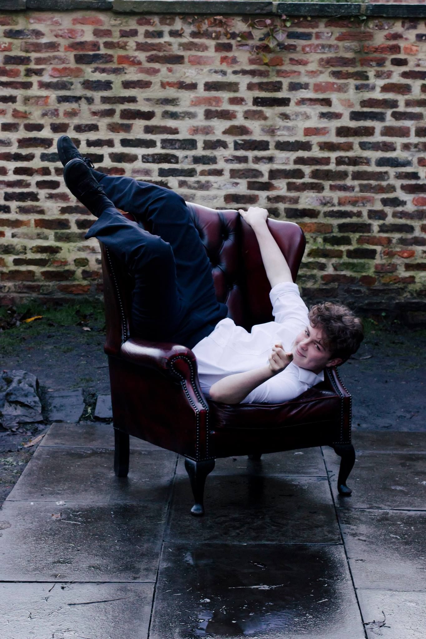 Image may contain: Asleep, Furniture, Chair, Brick, Person, People, Human