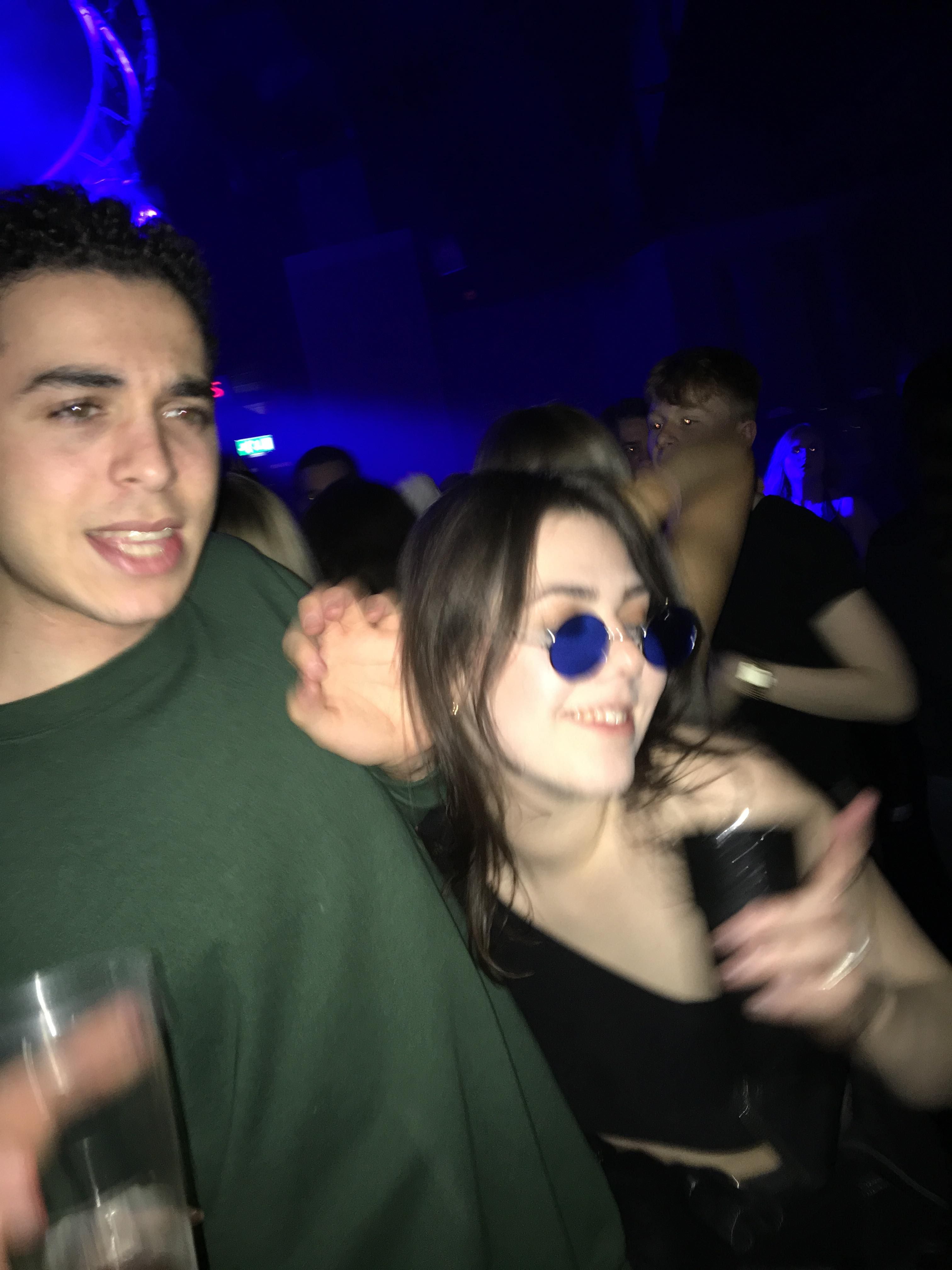 Image may contain: Drink, Beverage, Party, Bar Counter, Pub, Night Life, Night Club, Club, Sunglasses, Accessory, Accessories, Human, Person