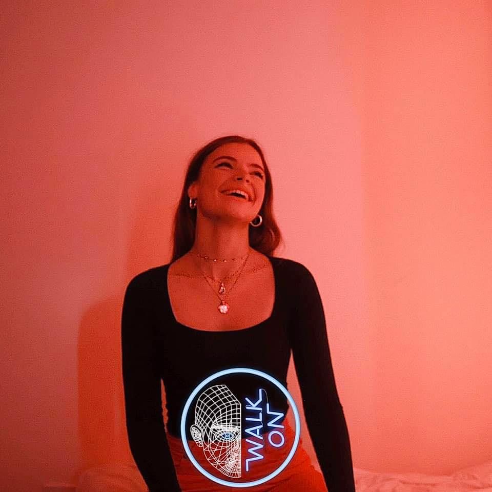 Image may contain: Skin, T-Shirt, Text, Face, Female, Long Sleeve, Human, Person, Sleeve, Clothing, Apparel