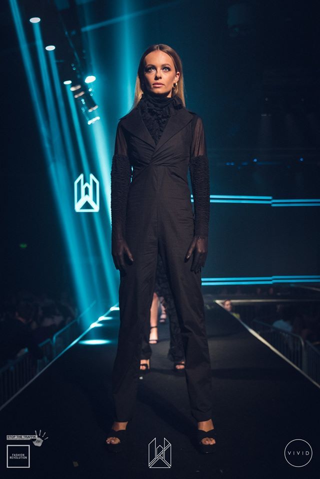 Image may contain: Stage, Fashion, Runway, Coat, Overcoat, Clothing, Apparel, Human, Person