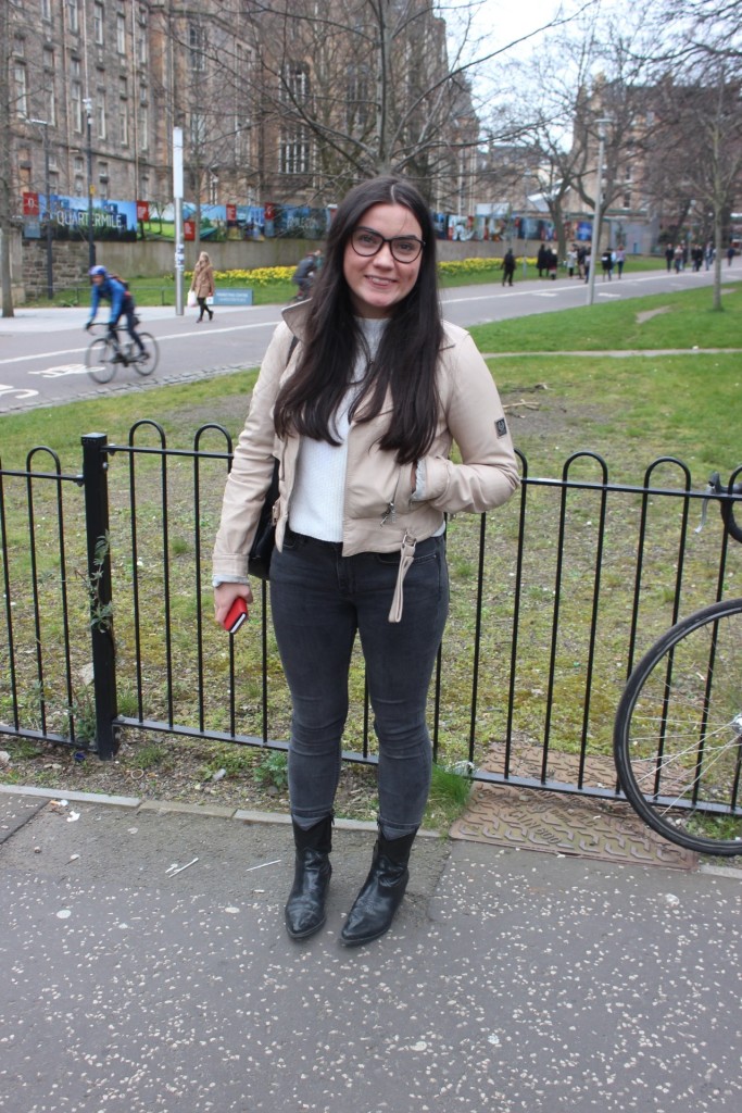 Light to Dark - Pippa wears a white sweater with a beige jacket on top, and on the bottom some classic black skinnies and leather boots.