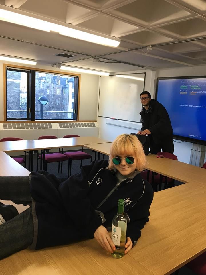 Image may contain: Liquor, Drink, Beverage, Alcohol, Room, Meeting Room, Indoors, Conference Room, Speech, Crowd, Audience, Bottle, Person, People, Human, Furniture, Couch
