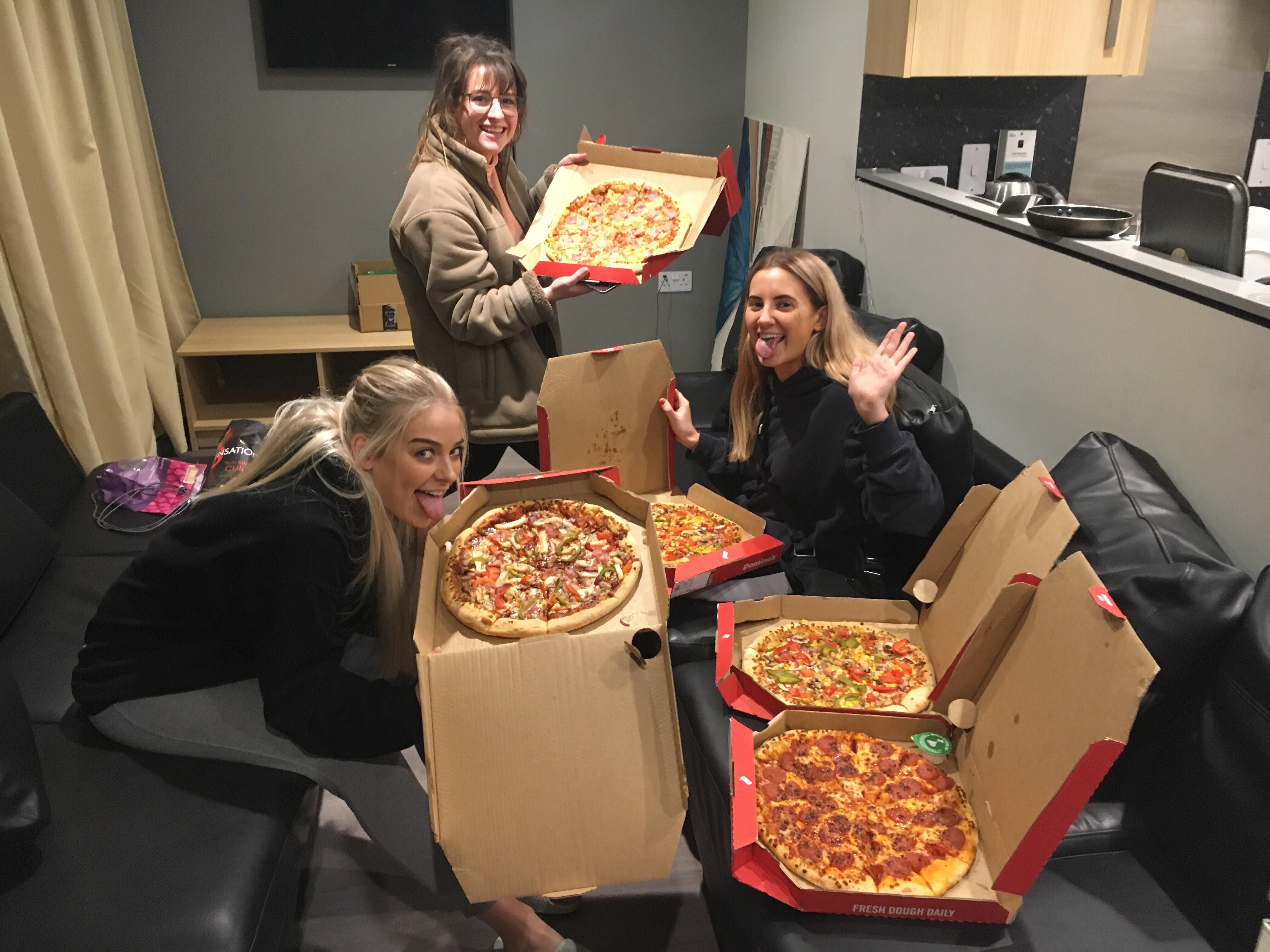 Image may contain: Person, People, Human, Pizza, Food