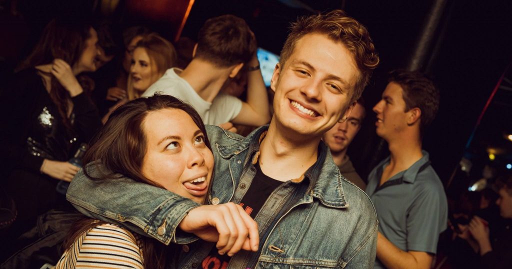 Image may contain: Denim, Jeans, Party, Crowd, Interior Design, Indoors, Pants, Apparel, Clothing, People, Club, Night Life, Dating, Face, Human, Person