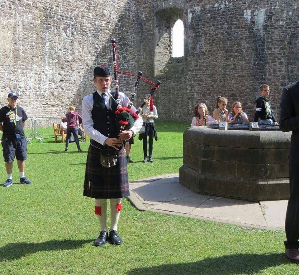 Image may contain: Tartan, Plaid, Skirt, Bow, Bagpipe, Musical Instrument, Leisure Activities, Clothing, Apparel, Human, Person