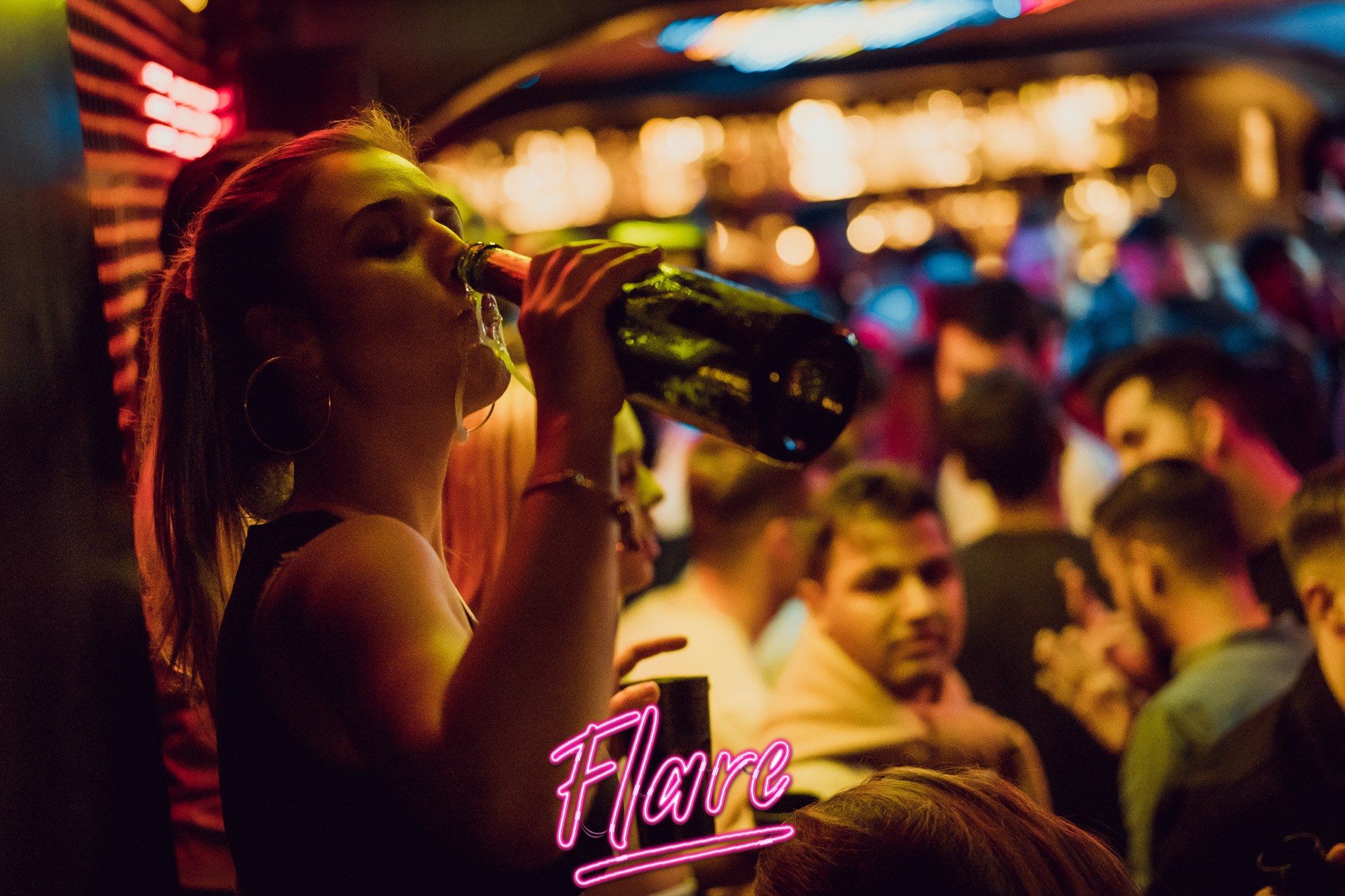 Image may contain: Beverage, Drink, Lighting, Bar Counter, Pub, Night Life, Person, Human