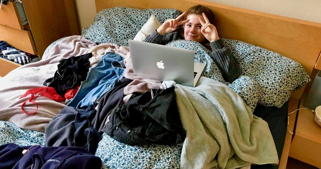 Image may contain: Bed, Person, Human, Couch, Furniture, Laptop, Electronics, Computer, Pc