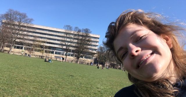 Image may contain: Vegetation, Tree, Campus, Female, Office Building, Building, Outdoors, Park, Lawn, Head, College, Face, Human, Person, Plant, Grass
