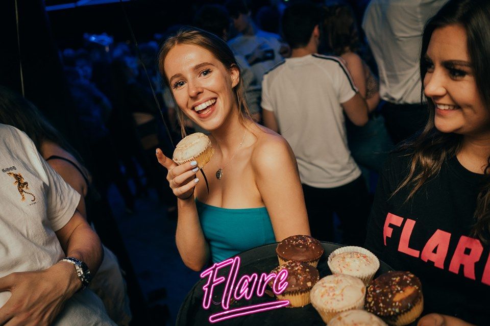 Image may contain: Bar Counter, Pub, Sweets, Confectionery, Night Life, Bread, Food, Person, Human
