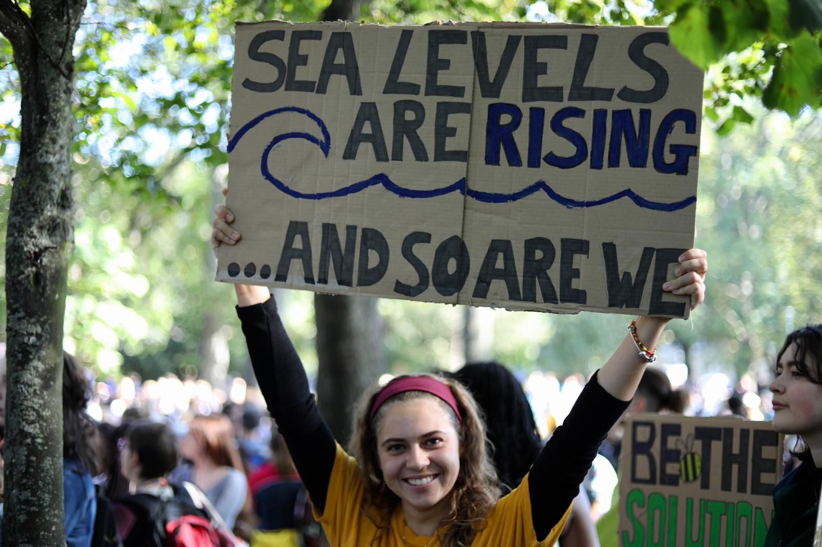 Image may contain: Crowd, Banner, Human, Person, Text