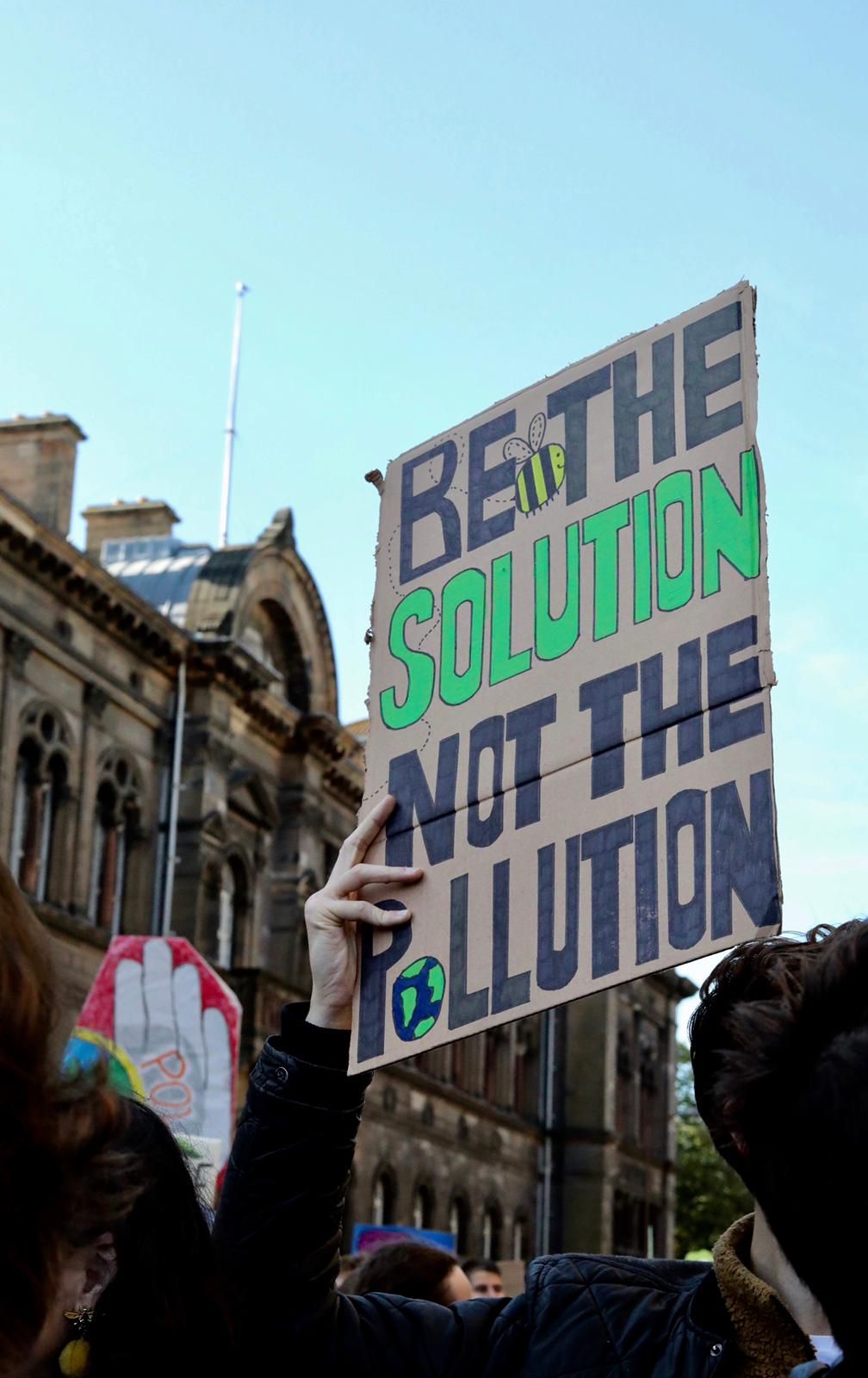 Image may contain: Crowd, Human, Person, Banner, Text
