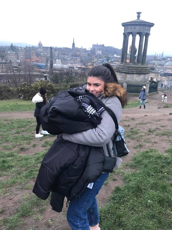 Image may contain: Portrait, Photography, Photo, Bag, Woman, Hug, Vacation, Face, Female, Apparel, Clothing, Building, Architecture, Person, Human