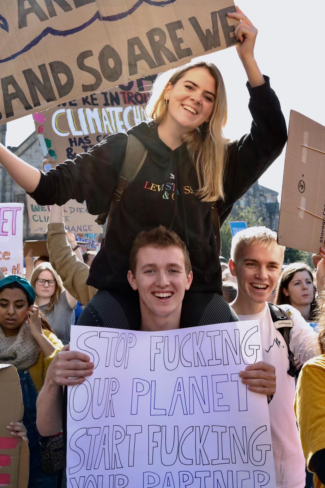 Image may contain: Vehicle, Offroad, Transportation, People, Text, Crowd, Parade, Protest, Person, Human