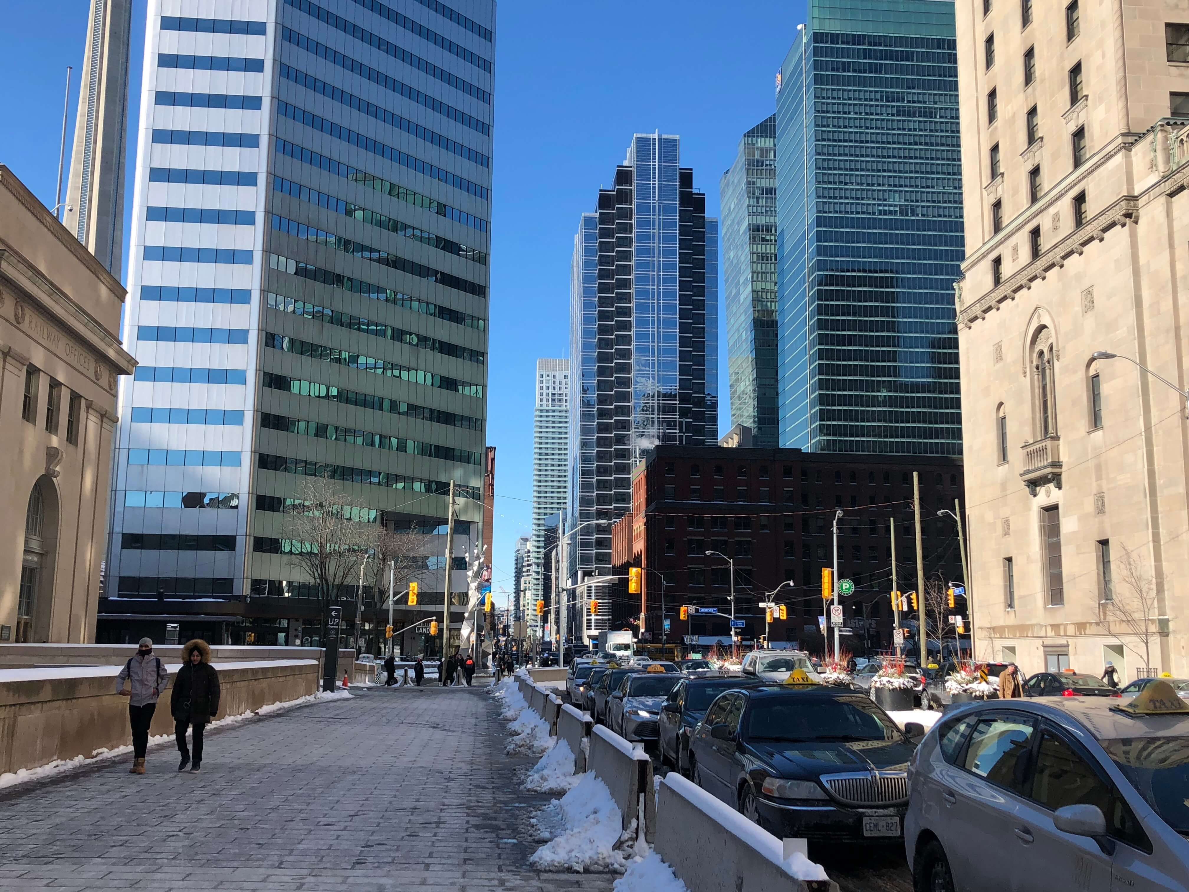 Image may contain: Architecture, Office Building, Intersection, Downtown, Road, Transportation, Car, Automobile, Vehicle, Metropolis, Urban, Building, Town, City, Person, Human