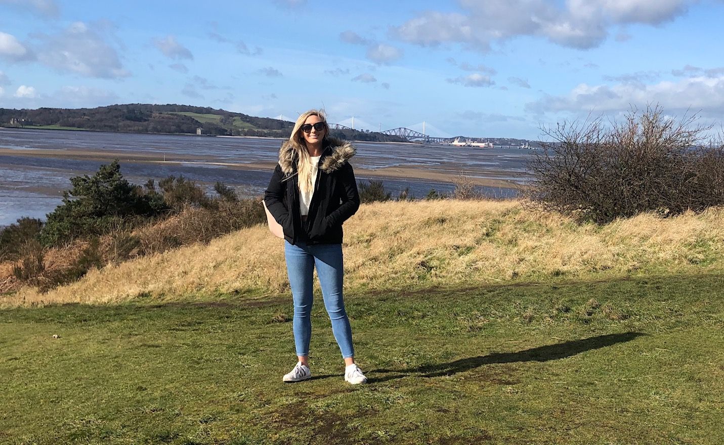 Image may contain: Grassland, Denim, Jeans, Grass, Plant, Coat, Jacket, Field, Accessory, Accessories, Sunglasses, Nature, Outdoors, Pants, Footwear, Clothing, Apparel, Shoe, Human, Person