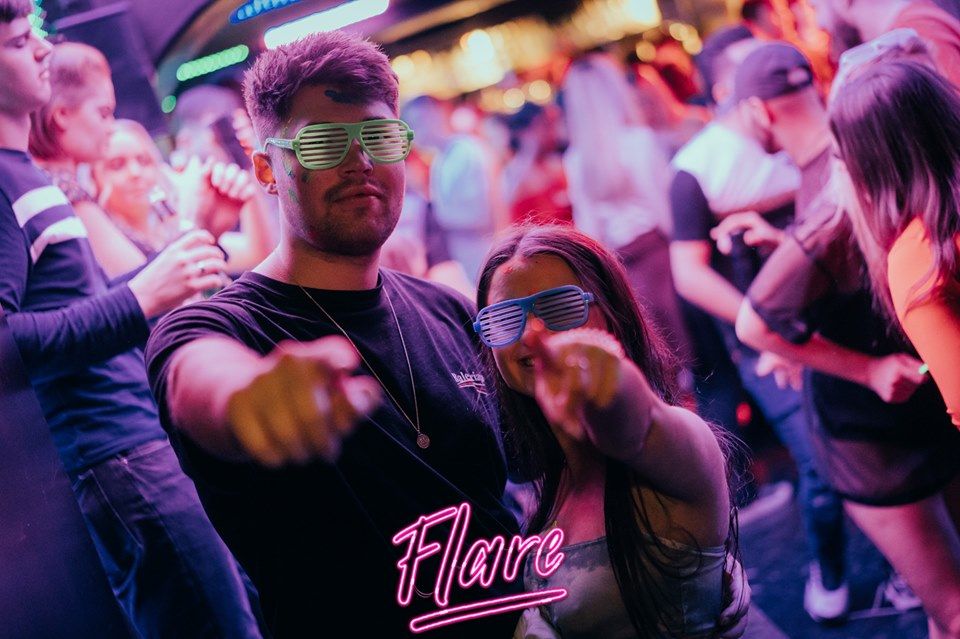 Image may contain: Guitar, Musical Instrument, People, Leisure Activities, Crowd, Skin, Night Club, Party, Club, Night Life, Accessory, Accessories, Sunglasses, Human, Person