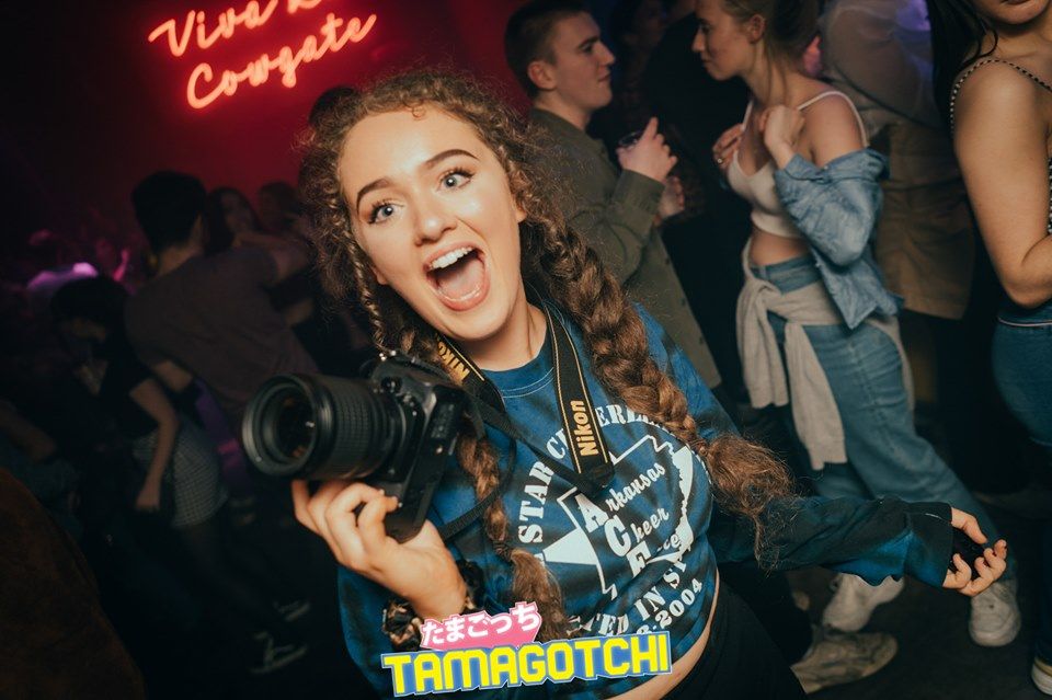 Image may contain: Leisure Activities, Party, Girl, Photographer, Female, Electronics, Camera, Face, Shoe, Clothing, Apparel, Footwear, Night Life, Human, Person