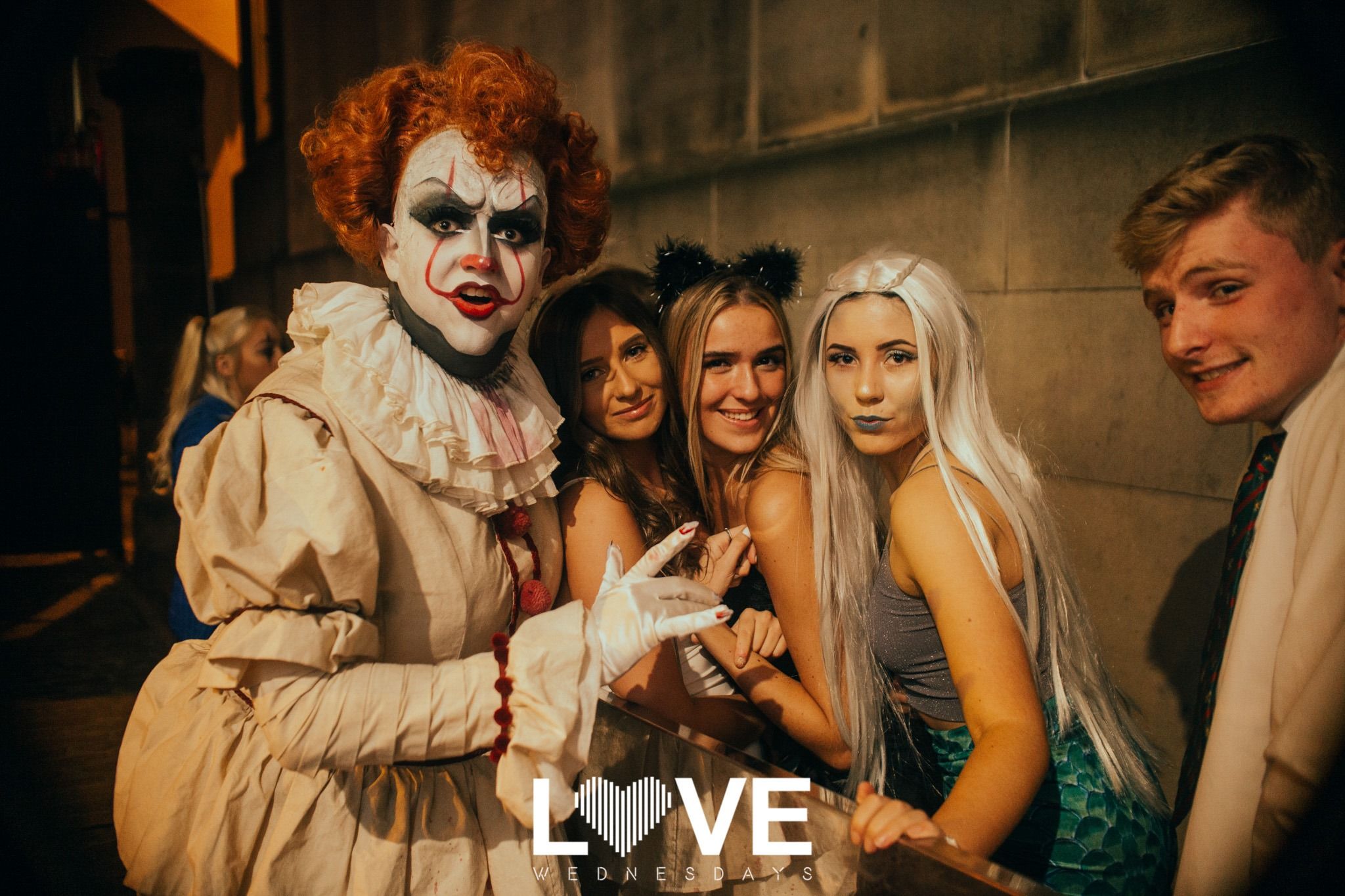 Image may contain: Clown, Apparel, Overcoat, Clothing, Coat, Suit, Person, Human, Performer