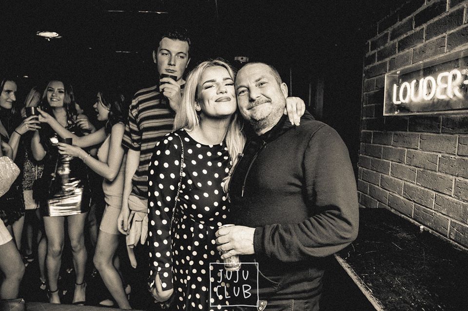 Image may contain: Night Life, Texture, Brick, Night Club, Apparel, Shoe, Footwear, Clothing, Party, Face, Club, Human, Person