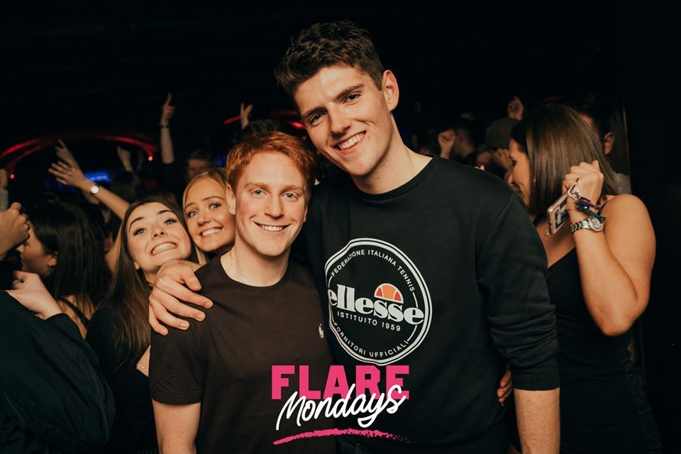 Image may contain: Apparel, Clothing, Crowd, Audience, Face, Indoors, Interior Design, Night Life, Night Club, Party, Club, Person, Human